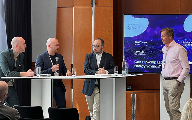 Audio visual industry experts discuss LED technology in front of an LCD Display