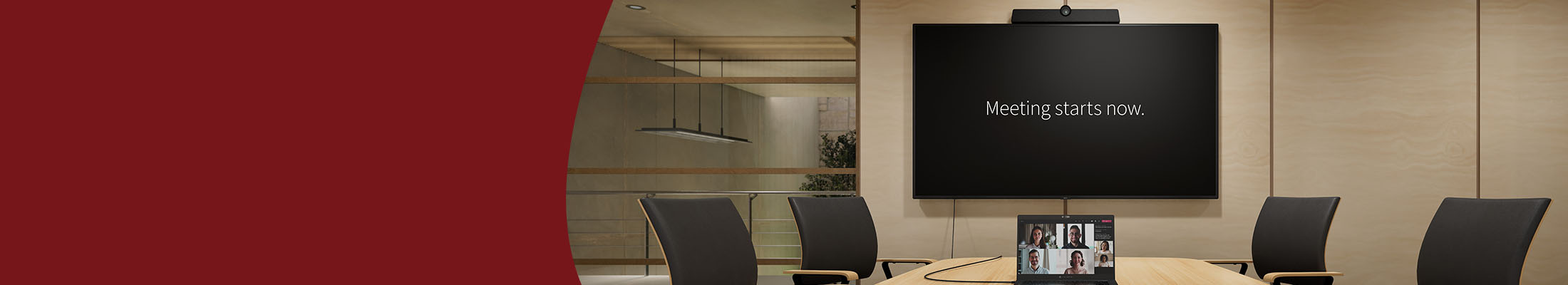 an empty meeting room with a cable connecting a laptop with a wall mounted display