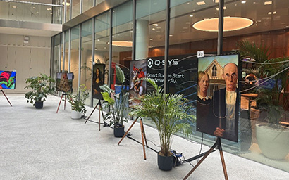 Digital artwork presented on easels in an office foyer