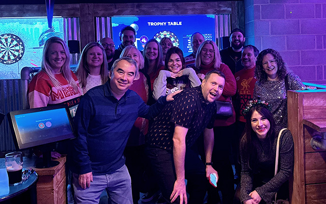 A group of people smiling at a Christmas party